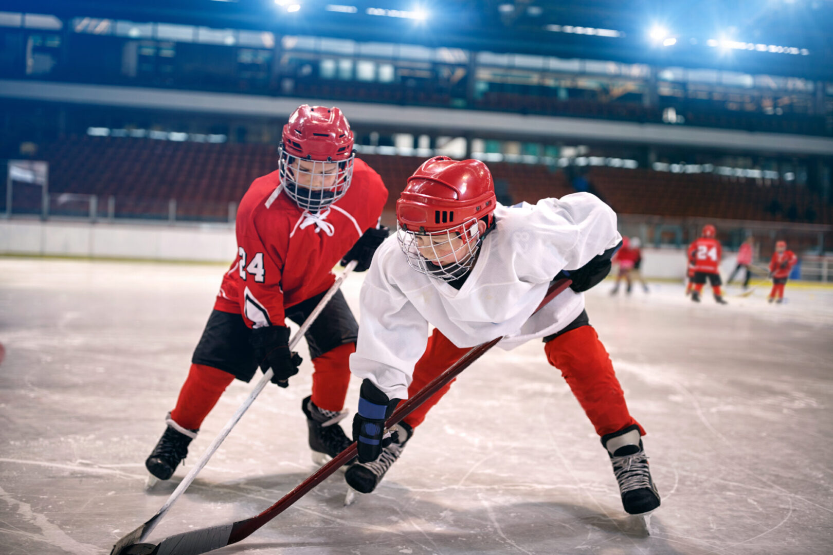 young children play ice hockey